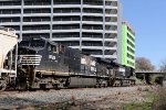 NS 9464 & 9726 lead train E25 past new construction in downtown